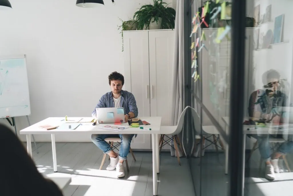 concentrated businessman using laptop in office